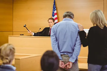 image of a man being represented by a female court appointed employee in front of a judge