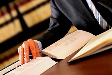 An image of a man researching various judicial resources for information.