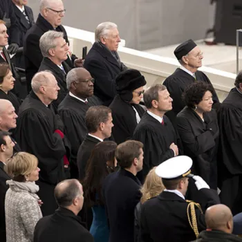 Members of the U.S. Supreme Court stand during ceremony.