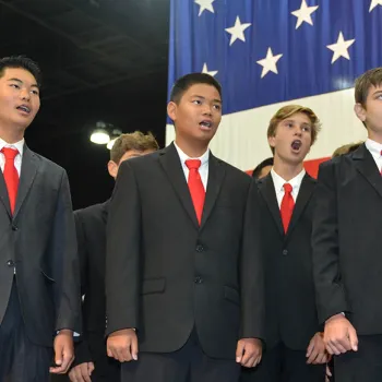 Students singing the National Anthem.