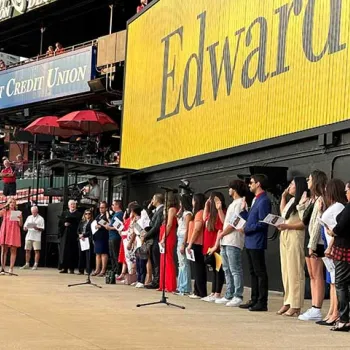 New U.S. citizens recite the Oath of Allegiance during a naturalization ceremony at Busch Stadium in St. Louis.