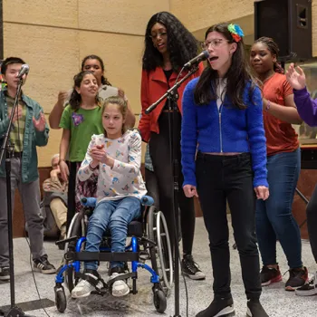 A song from the musical "The Girl Who Cried Different" is performed during a public reception at the Minneapolis courthouse. 