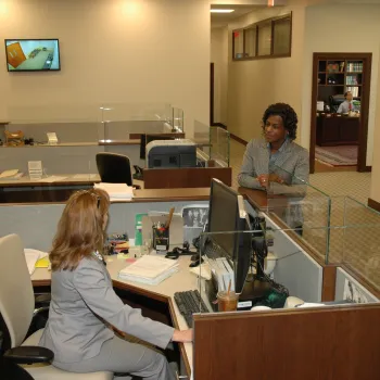 Judicial Assistant Sharon Townsend, foreground, speaks with Valerie Sutton, a space and facilities specialist.