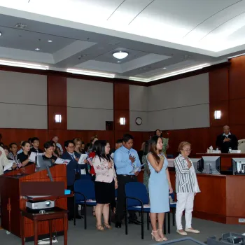 Naturalization ceremony attendees in Guam say the pledge of allegiance.