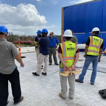 Chief Judge S. Maurice “Maury” Hicks (center, in blue shirt) inspects the roof of the Lake Charles courthouse. 