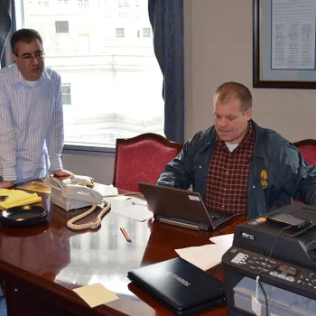 District Court Executive Edward A. Friedland and Chief Probation Officer Michael Fitzpatrick work in a makeshift command center to alert employees and jurors about court closures and restoring courthouse operations.