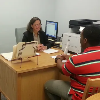 Center director Nancy Rosenbloom helps a pro se litigant in an office in the Eastern District of New York federal courthouse in Brooklyn.