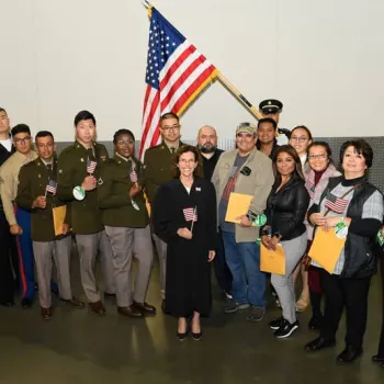 New citizens and U.S. Bankruptcy Judge Sandra R. Klein pose for a group photo at SoFi Stadium.