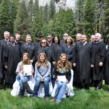 At a Yosemite Valley ceremony, student essay contest winners are flanked by 16 federal and state judges. 