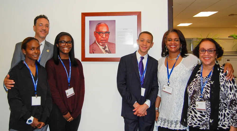 Leon E. DeKalb’s family members pose with a photo of him during a 2016 ceremony honoring probation officers in the Southern District of New York