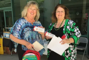 People hold emergency kits that were available at the fairs.