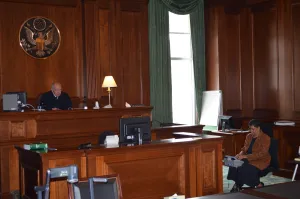 U.S. District Judge P. Kevin Castel presided over a time-sensitive international abduction case in the Moynihan Courthouse, which lost power due to the storm, using a temporary table lamp and natural sunlight to light the courtroom.