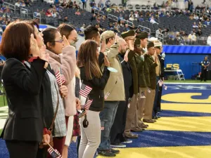 New citizens recite the Oath of Allegiance on the football field before a Los Angeles Rams game. 